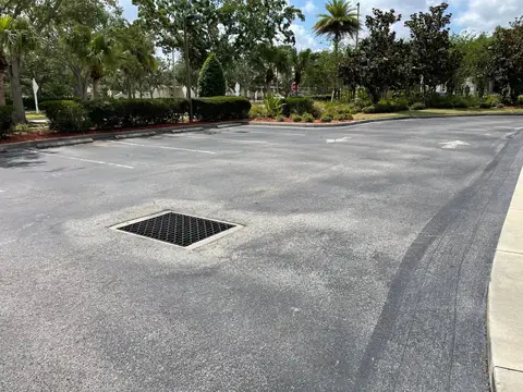 Smooth asphalt entrance with clear markings in a commercial area