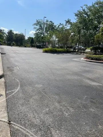 Well-maintained asphalt road with clear signage in Cape Coral